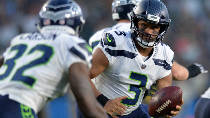 Seattle Seahawks quarterback Russell Wilson (3) looks to hand the ball off to running back Chris Carson (32) during the first quarter against the Los Angeles Chargers