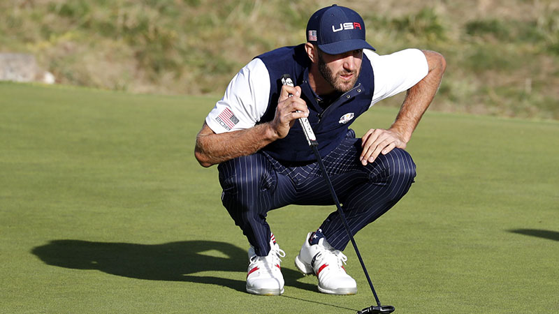 dustin johnson reading a putt at the Ryder cup