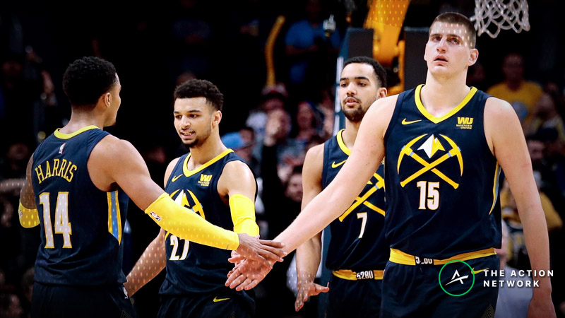 Orlando Magic's D.J. Augustin (14) looks for an opening past Utah Jazz's  Joe Ingles, middle, as Magic's Bismack Biyombo stands near Ingles during  the first half of an NBA basketball game Saturday