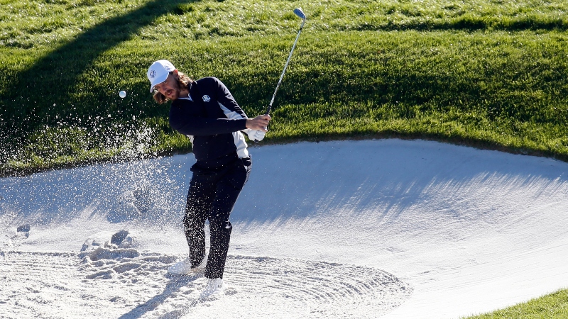 European golfer Tommy Fleetwood hits out of a sand trap during a Ryder Cup practice round at Le Golf National.