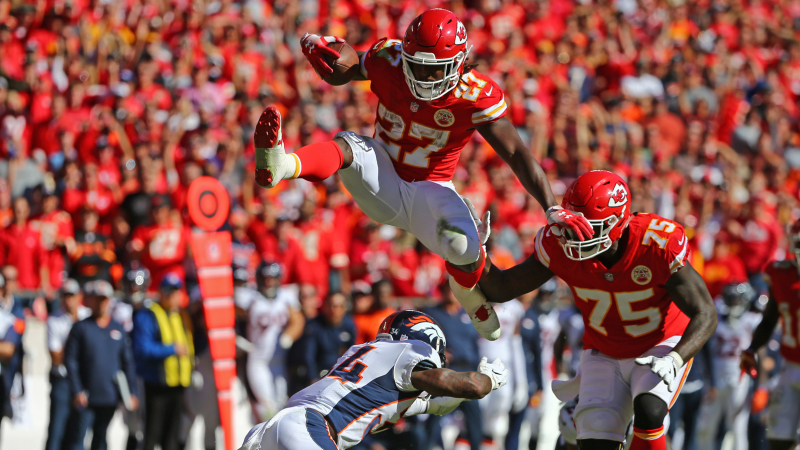 Kansas City Chiefs running back Kareem Hunt (27) hurdles Denver Broncos safety Will Parks (34) in the second half at Arrowhead Stadium.