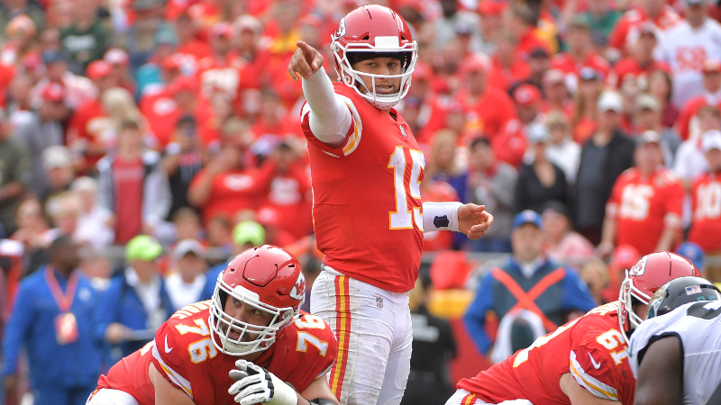 Kansas City Chiefs quarterback Patrick Mahomes (15) and offensive guard Laurent Duvernay-Tardif (76) gesture at the line of scrimmage during the game against the Jacksonville Jaguars at Arrowhead Stadium.