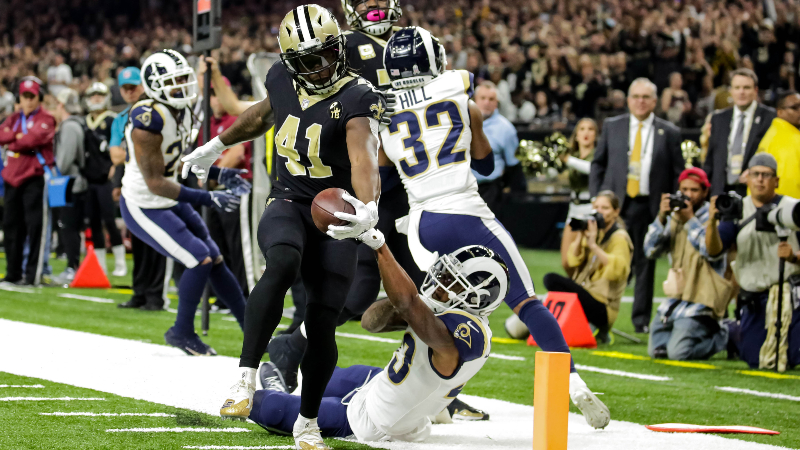 New Orleans Saints running back Alvin Kamara (41) breaks a tackle by Los Angeles Rams strong safety John Johnson (43) to score a touchdown during the first quarter at the Mercedes-Benz Superdome.