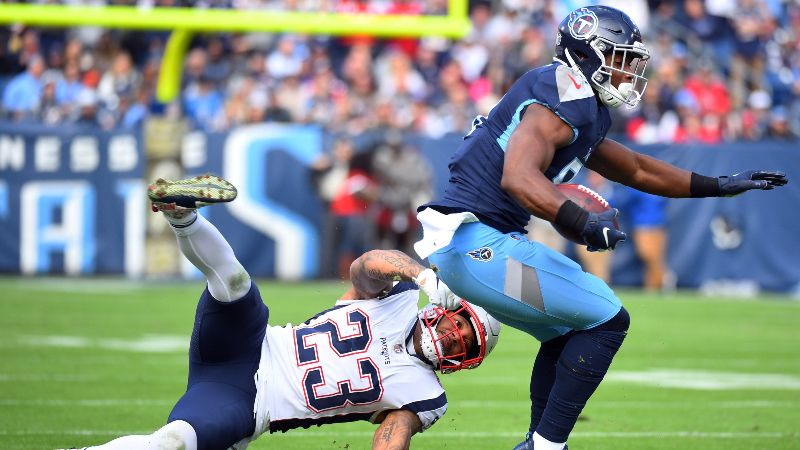Tennessee Titans tight end Jonnu Smith (81) pulls away from a tackle attempt by New England Patriots strong safety Patrick Chung (23) during the first half at Nissan Stadium.