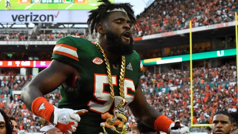 Miami Hurricanes linebacker Michael Pinckney (56) celebrates with the turn over chain after intercepting a pass during the second half against the Florida State Seminoles at Hard Rock Stadium.