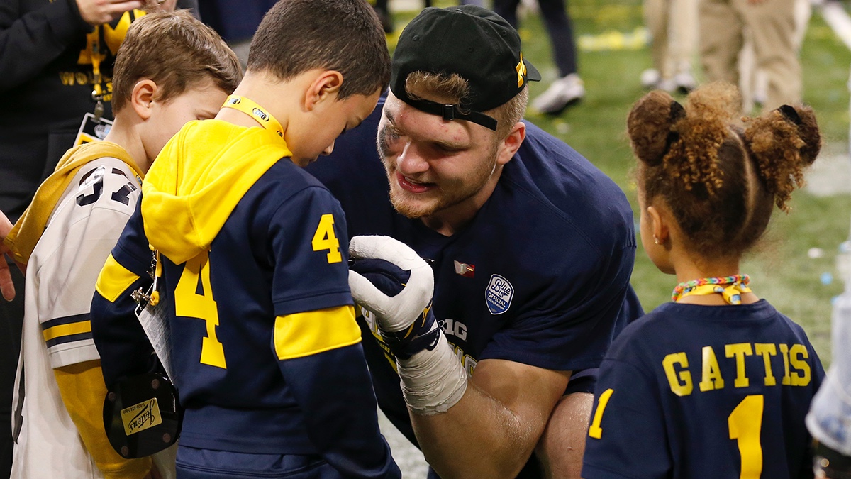 M Den selling Michigan football jerseys with players' names on the back 