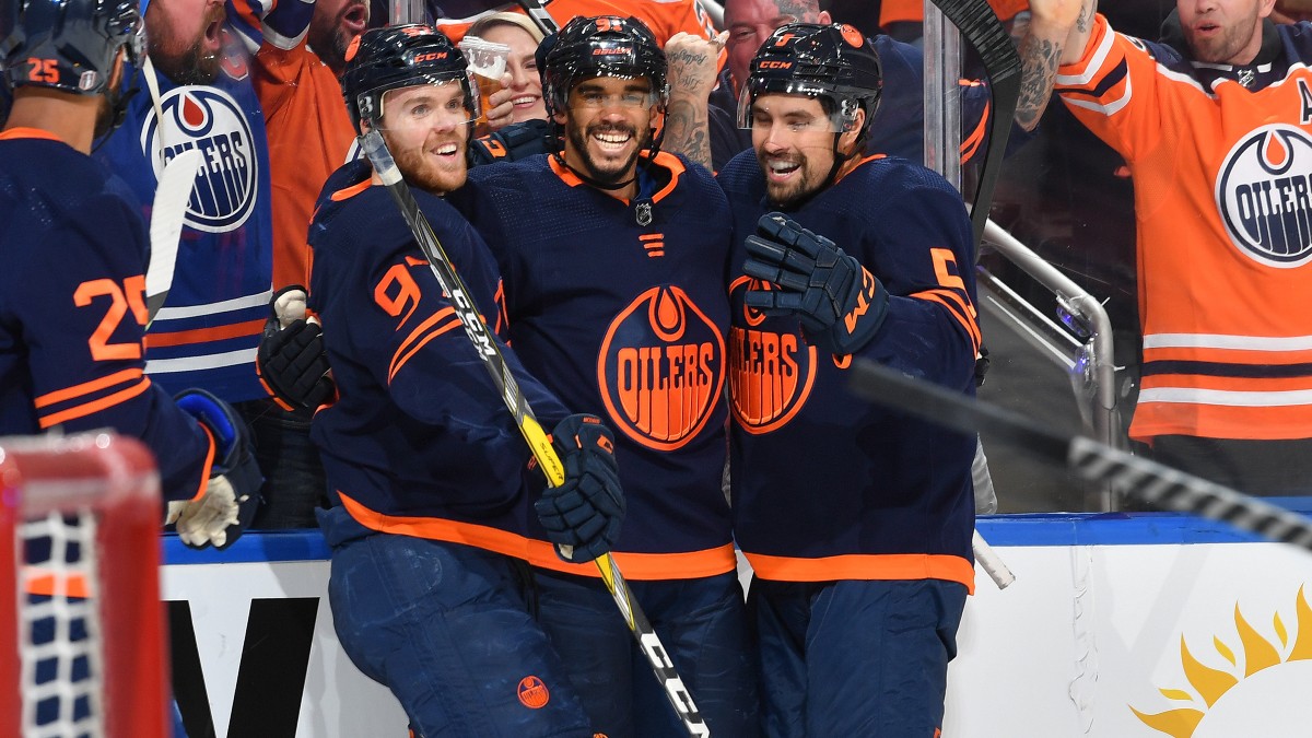 Edmonton Oilers' Cody Ceci (5) and Darnell Nurse (25) check Chicago  Blackhawks' Andreas Athanasiou as Ceci looks for the puck during the first  period of an NHL hockey game Wednesday, Nov. 30