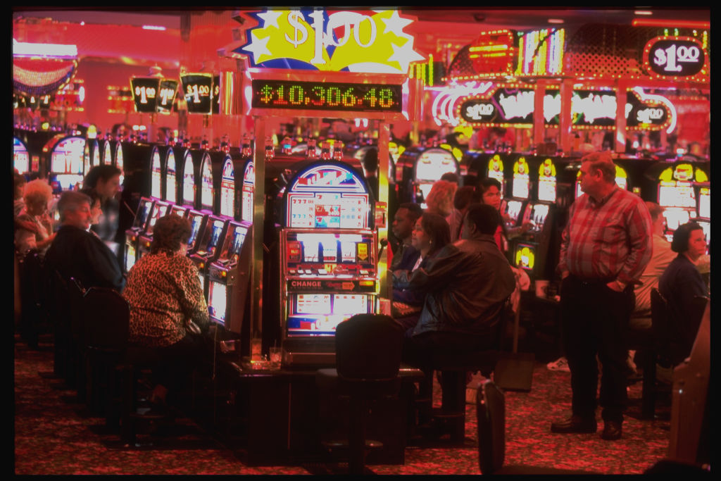 People playing slot machines at Grand Casino in Mississippi, supporting its thriving gambling industry. 