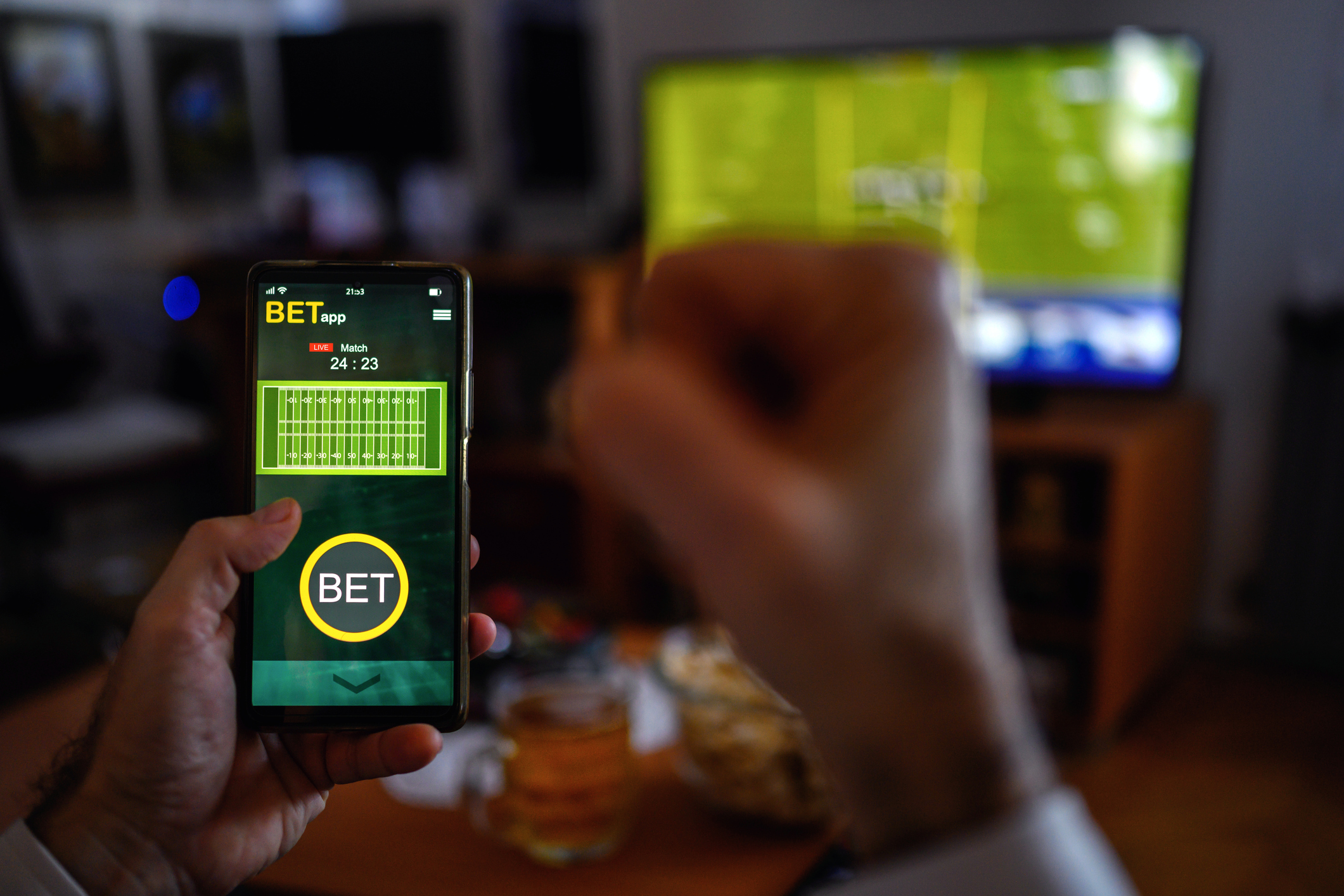 Man placing live sports bets on American Football game. H
