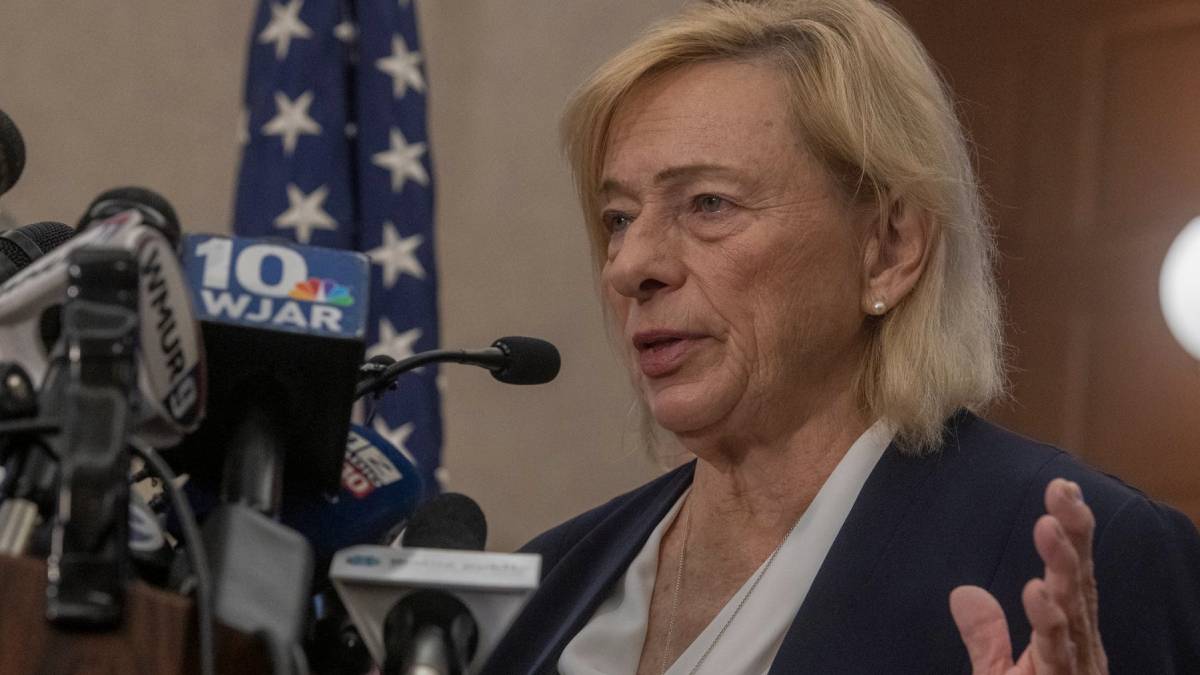 Maine Governor Janet Mills at a press conference, announcing the approval of legislation that legalizes online gambling for the Wabanaki Nations. She stands at a podium with a serious expression, highlighting the potential economic benefits for tribal communities.