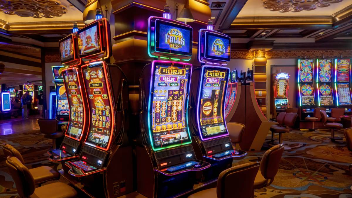 Row of brightly lit slot machines inside a casino, highlighting the vibrant gaming environment that could be part of the Alabama gambling landscape.