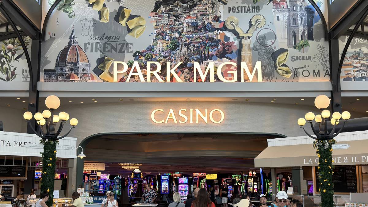 Overview of the Park MGM casino floor, showcasing a variety of gaming tables and slot machines under bright lights.