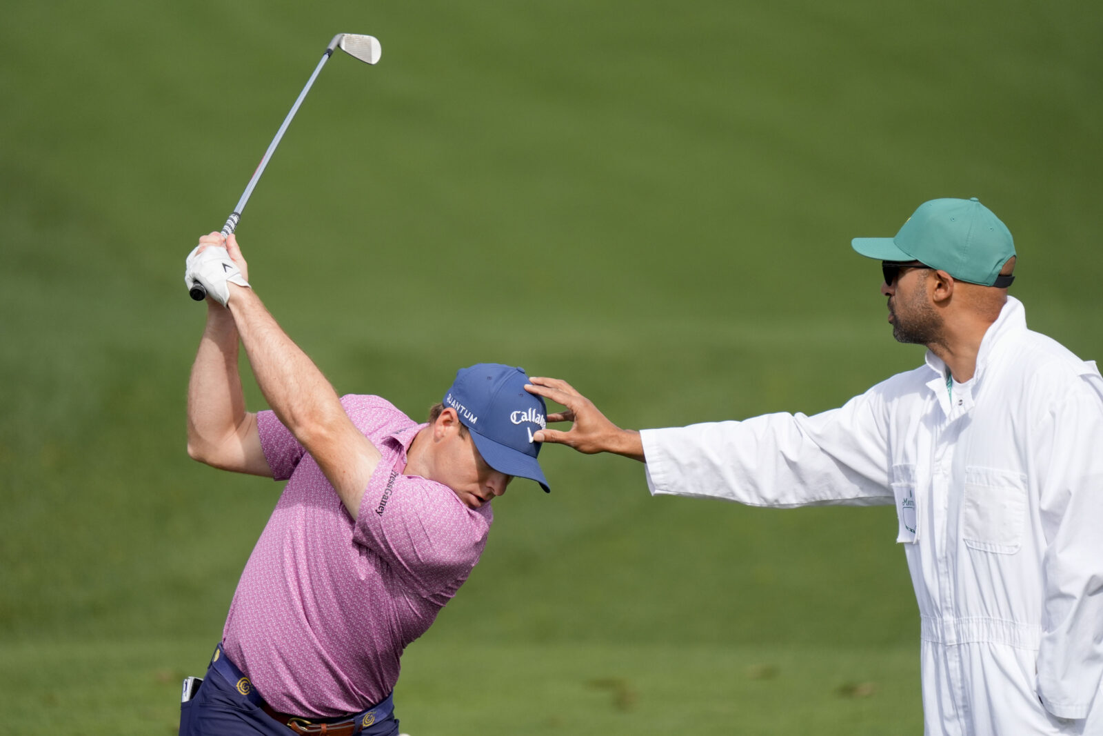 Apr 6, 2026; Augusta, Georgia, USA; Max Greyserman hits at the practice facility while being supported by his caddie, Adam Parmer, during a practice round for the Masters Tournament at Augusta National Golf Club.