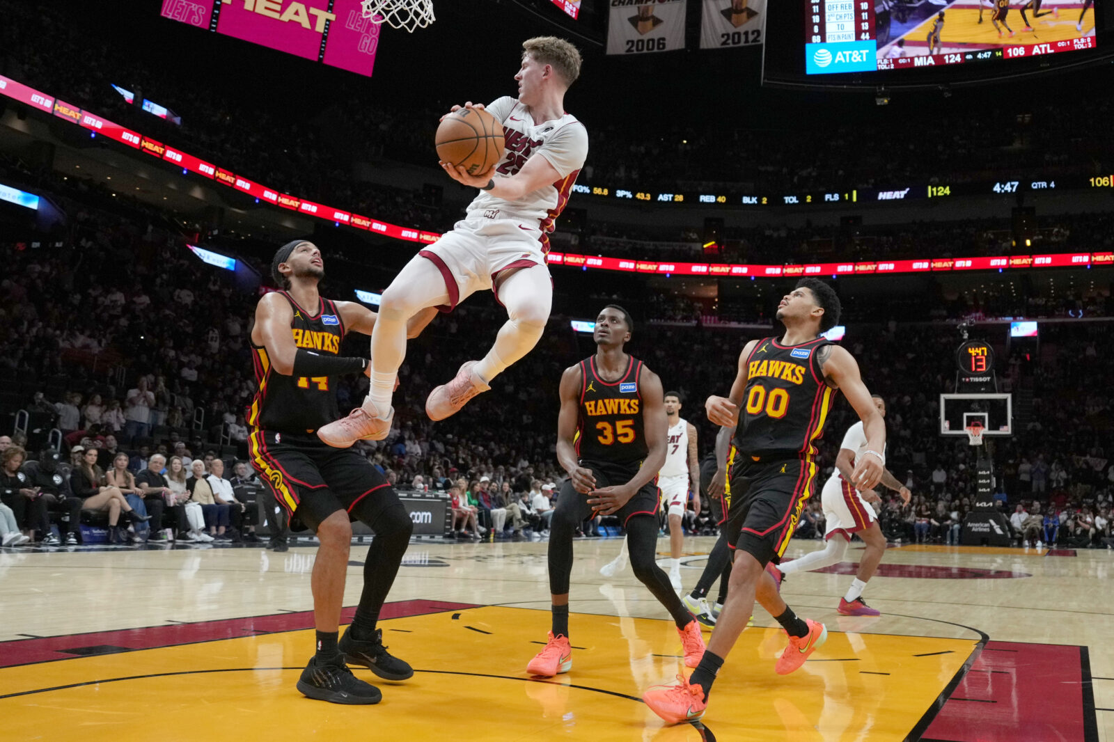 Apr 12, 2026; Miami, Florida, USA; Miami Heat guard Kasparas Jakucionis (25) passes against Atlanta Hawks forward Onyeka Okongwu (17), center Christian Koloko (35) and guard Rayj Dennis (00) during the second half at Kaseya Center. 