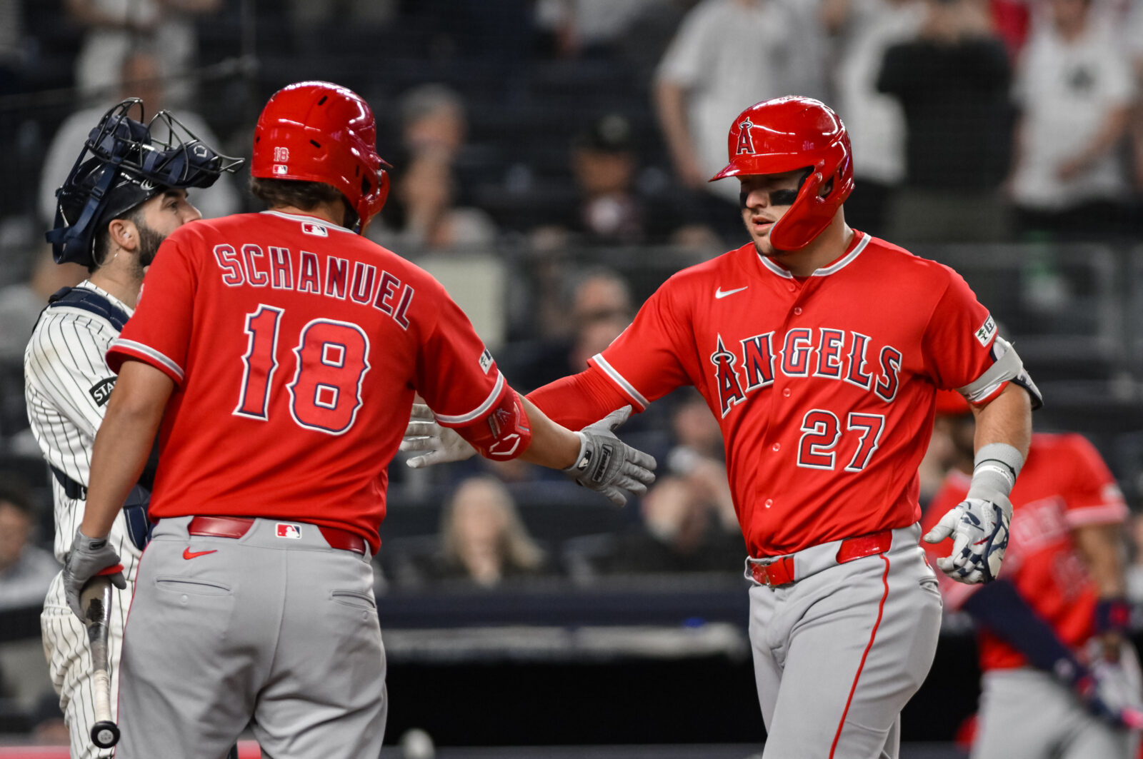 Apr 13, 2026; Bronx, New York, USA; Los Angeles Angels right fielder Mike Trout (27) is greeted at home plate by first baseman Nolan Schanuel (18) after hitting a two run home run against the New York Yankees during the eighth inning at Yankee Stadium.