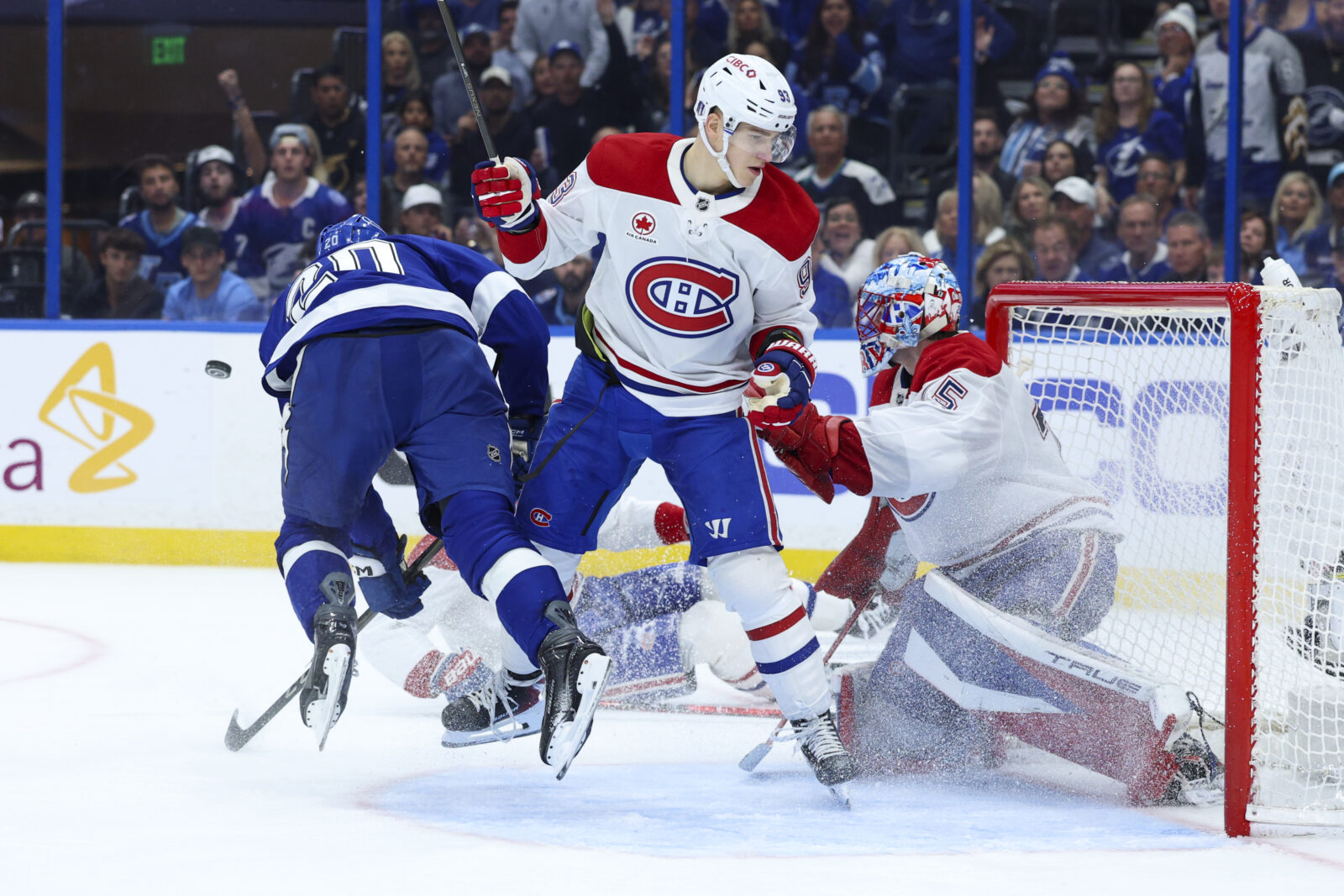 Tampa Bay Lightning left wing Nick Paul is tripped up in front of the goal by Montreal Canadiens right wing Ivan Demidov in the third period during game two of the first round of the 2026 Stanley Cup Playoffs at Benchmark International Arena.