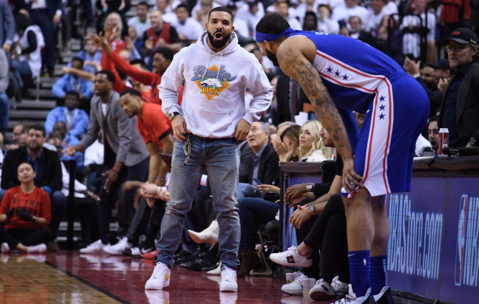 May 7, 2019; Toronto, Ontario, CAN; Canadian singer & rapper Drake interacts with Philadelphia 76ers forward Mike Scott (1) during the second quarter in game five of the second round of the 2019 NBA Playoffs at Scotiabank Arena.
