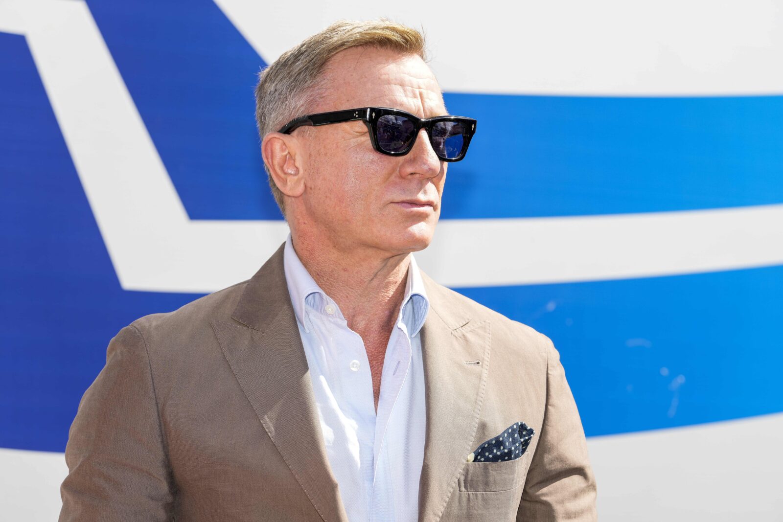 Oct 10, 2021; Concord, North Carolina, USA; Honorary starter actor Daniel Craig talks to the media before the start of the Bank of America Roval 400 at Charlotte Motor Speedway Road Course. 