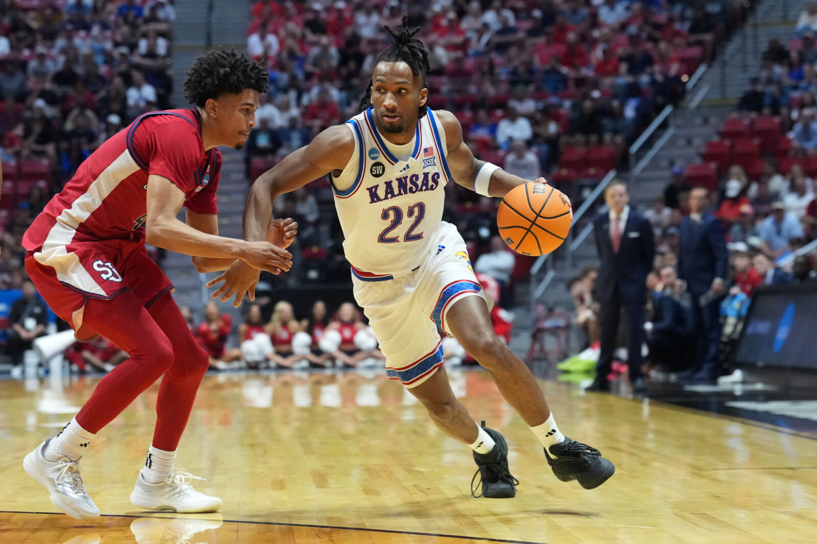 Kansas Jayhawks guard Darryn Peterson controls the ball against St. John's Red Storm guard Oziyah Sellers in the second half during a second round game of the men's 2026 NCAA Tournament at Viejas Arena.