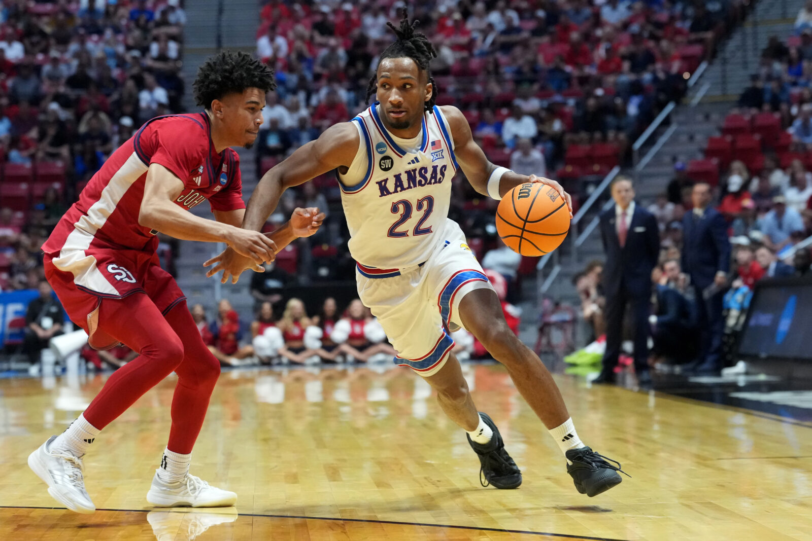 Mar 22, 2026; San Diego, CA, USA; Kansas Jayhawks guard Darryn Peterson (22) controls the ball against St. John's Red Storm guard Oziyah Sellers (4) in the second half during a second round game of the men's 2026 NCAA Tournament at Viejas Arena. 