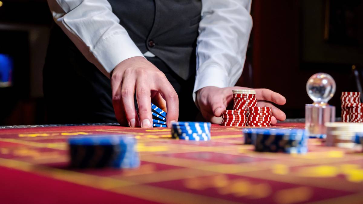 a baccarat dealer in a las vegas strip hotel gets ready to deal a new hand.