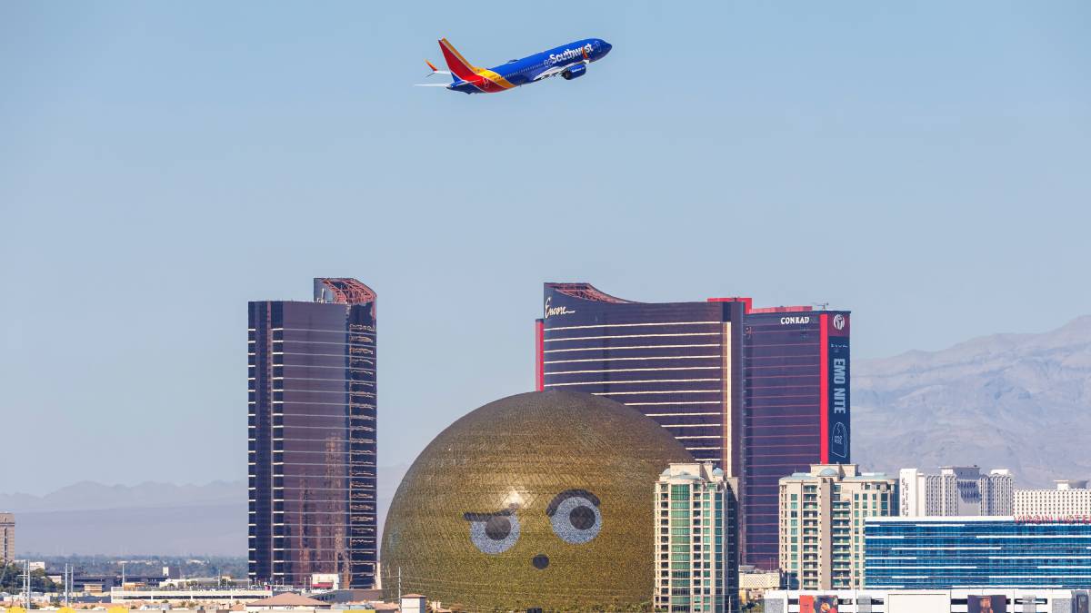 The Sphere in Las Vegas with a plane flying overhead against a clear sky.