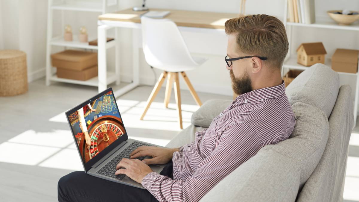 Live dealer casino screen displayed on a laptop for online gambling players.
