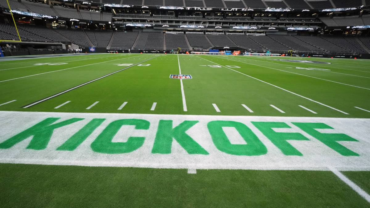 Sports fan reviews NFL betting and prediction-market prices on a mobile phone.