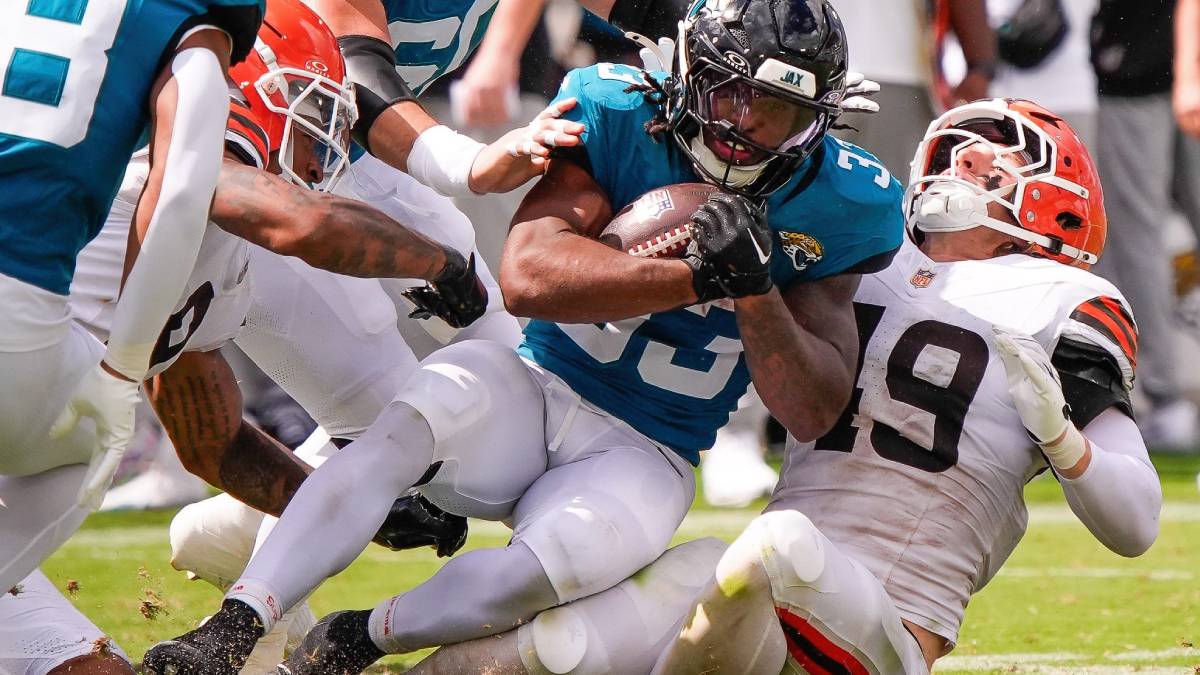 An NFL player makes a tackle during a football game