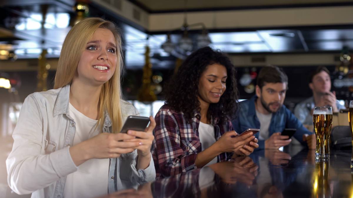 a woman uses one of the many prediction market apps to put in a contract on an nfl game.