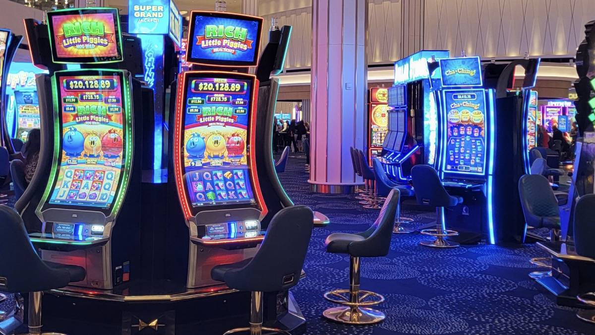 a casino gaming floor with slot machines and table-game areas.