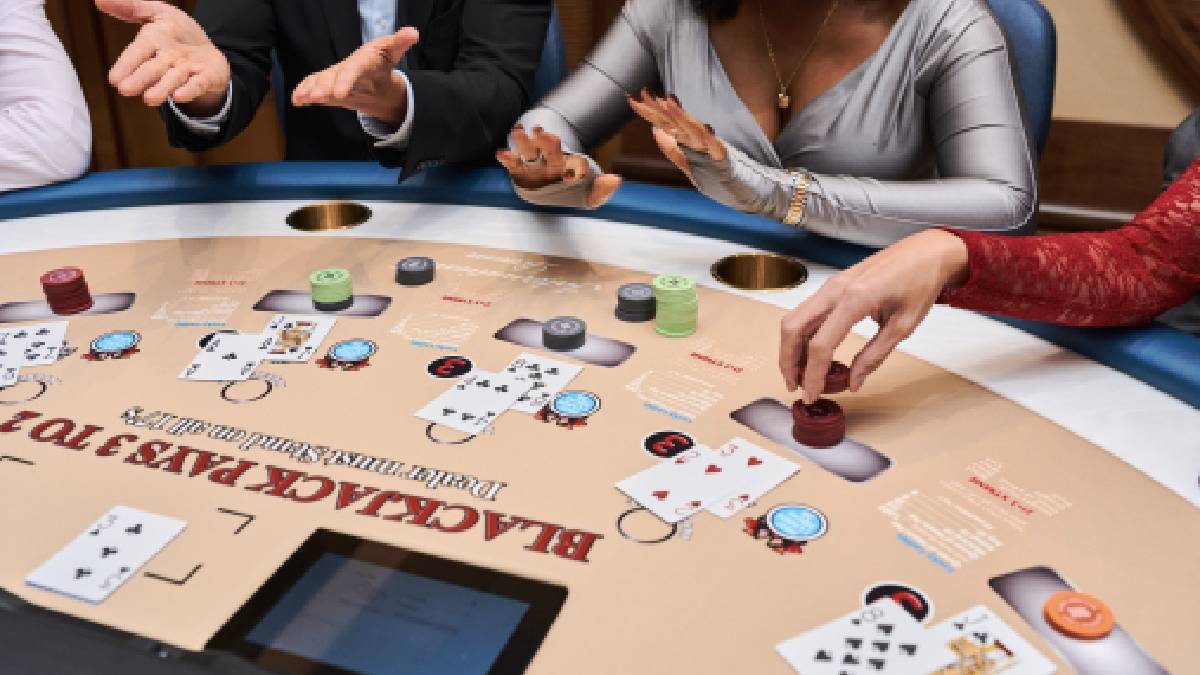 Players at a blackjack table inside the high-limit International Room at Resorts World New York City.